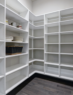 Large pantry filled with white shelving