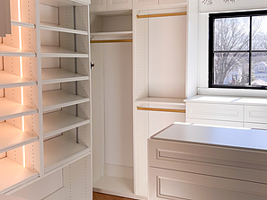 Corner of Walk-in Closet with Island and LED Lighting